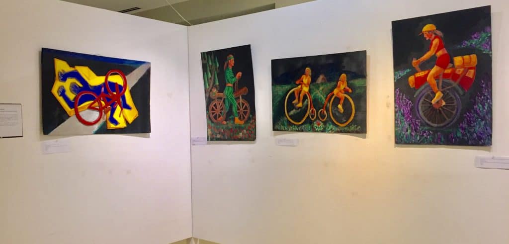 installation view of four bike art paintings at the Hairpin Art Center