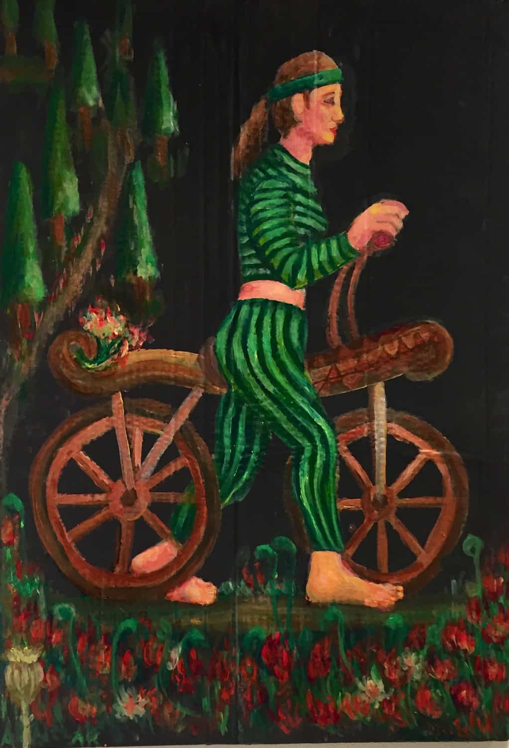 woman in striped black and green outfit riding a large wooden hobby horse in a poppy field